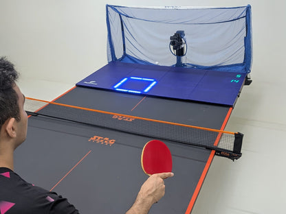 A table tennis player using the Fastpong system for table tennis practise