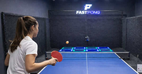 Woman playing table tennis at a Fastpong commercial installation