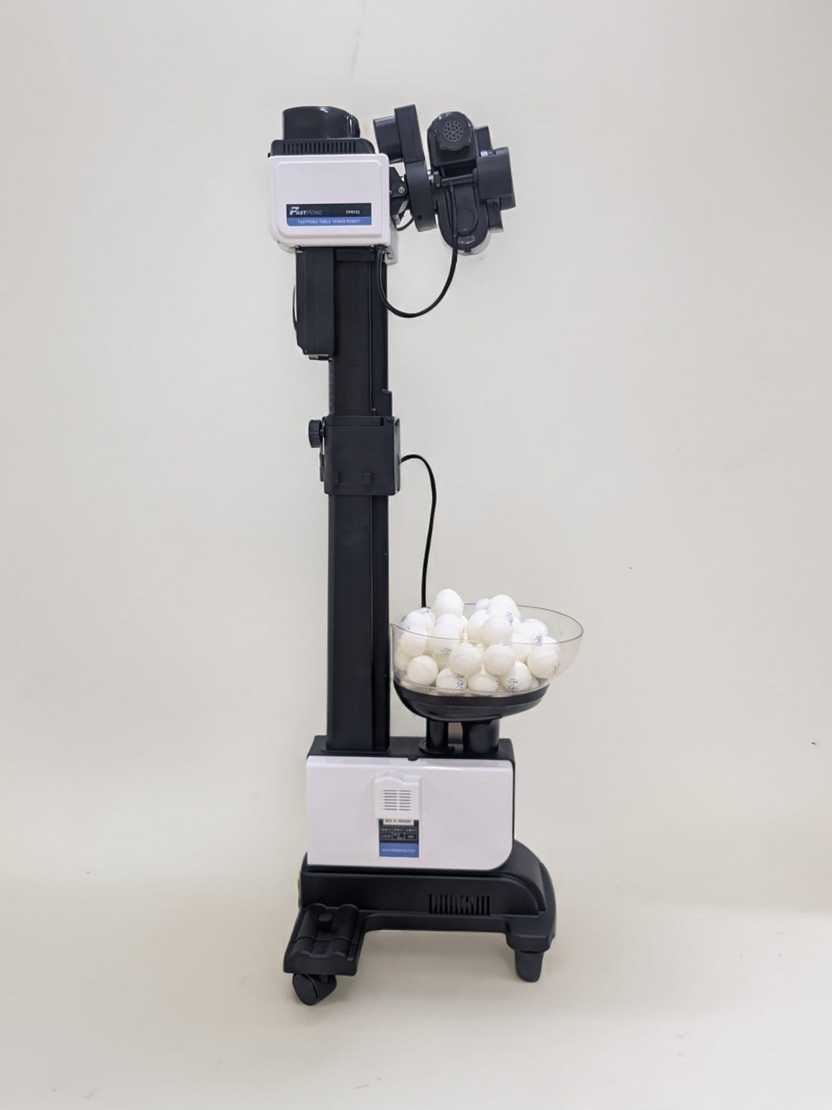 Fastpong table tennis robot from head to toe, with ping pong balls in the hopper
