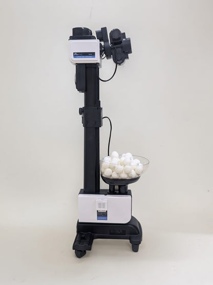 Fastpong table tennis robot from head to toe, with ping pong balls in the hopper