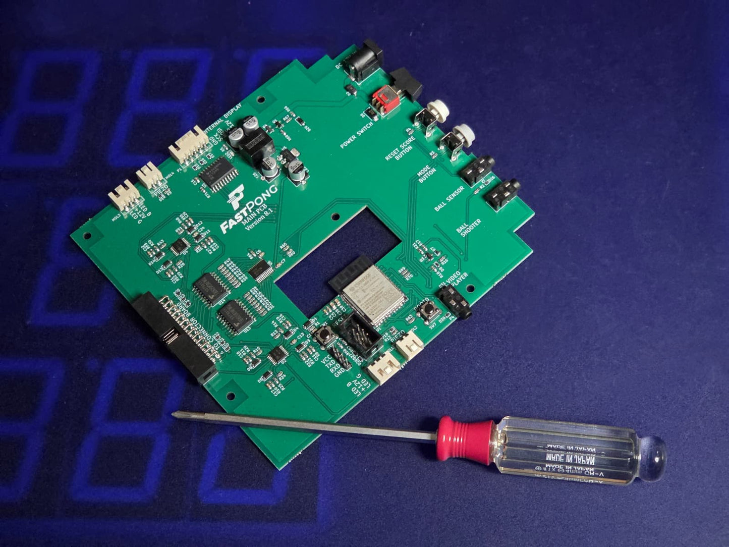 PCB and a screwdriver resting on a tile