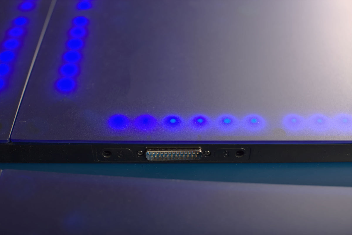 Showing how the Fastpong tiles connect to each other with a close up view of the connector. The tiles are number and there are also hidden magnets to ensure stability