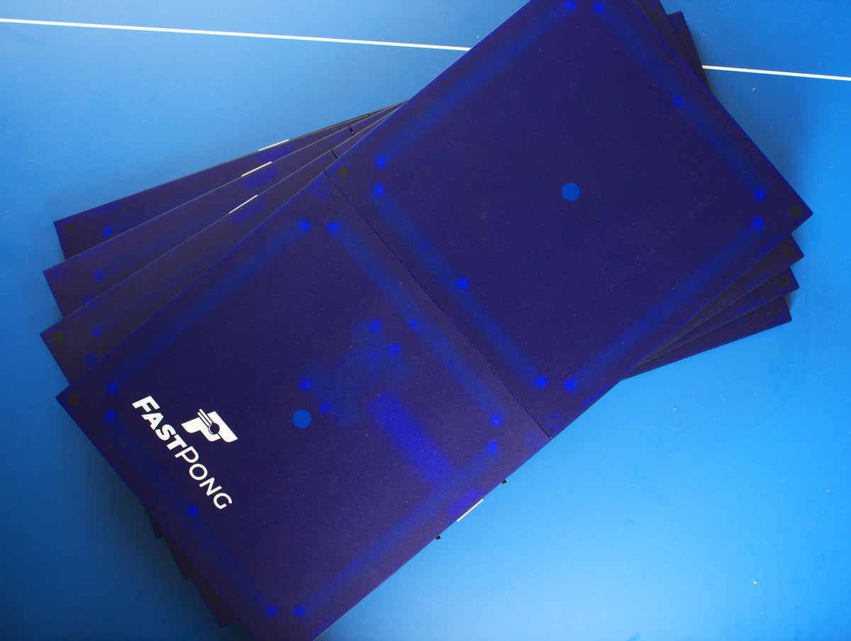 Top down view of four Fastpong tiles stacked on top of each other on a table tennis table